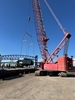 Tandemloc spreader beams lifting a specialized dust collection trailer onto a barge.